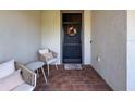Cozy front porch with seating, decorative wreath, and a welcoming doormat at 18743 Coastal Shore Ter, Land O Lakes, FL 34638