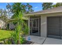 Close-up view of the home's entrance, showcasing the screened entry and well-maintained facade at 2295 Rio Cir, Spring Hill, FL 34608