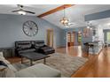 Spacious living room with hardwood floors, beamed ceilings, and stylish furnishings at 2295 Rio Cir, Spring Hill, FL 34608