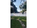 Spacious backyard featuring a well-maintained lawn, tall privacy fence, and potential for outdoor enjoyment at 2870 26Th N Ave, St Petersburg, FL 33713