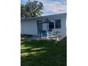 A pleasant backyard patio features an umbrella-shaded table and chairs perfect for outdoor relaxation and entertaining at 2870 26Th N Ave, St Petersburg, FL 33713
