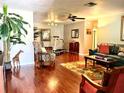 Spacious living room with hardwood floors, plush seating, and a cozy, inviting atmosphere at 3447 Paloma Dr, Holiday, FL 34690