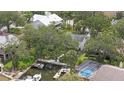 Aerial view of a house with a boat dock and pool in a residential neighborhood at 4439 Reeves Rd, New Port Richey, FL 34652