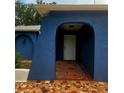 Inviting covered entrance with decorative tiled floor and arched doorway at 8504 Lafitte Dr, Hudson, FL 34667