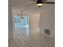 Bright living room with tile flooring, modern light fixtures, and an open layout at 8504 Lafitte Dr, Hudson, FL 34667