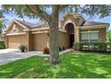 Inviting single-Gathering home with a three-car garage, a well-manicured lawn and mature trees at 9309 Edistro Pl, New Port Richey, FL 34654