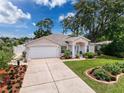 Charming single-story home featuring a well-manicured lawn and a two-car garage at 9431 Spring Hill Dr, Spring Hill, FL 34608
