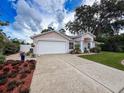 Well-maintained single-story home with a spacious driveway and attached two-car garage at 9431 Spring Hill Dr, Spring Hill, FL 34608