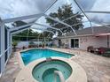 Screened-in pool and spa, perfect for relaxation and entertaining guests at 9431 Spring Hill Dr, Spring Hill, FL 34608