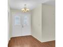 Entrance with wooden floors and white patterned glass doors at 9433 Stonewall Ln, New Port Richey, FL 34655