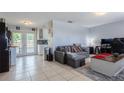 Bright and airy living room with tile floors and an open concept design at 9635 Century Dr, Spring Hill, FL 34608