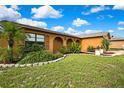 A lovely single-story home boasting mature landscaping and a well-maintained lawn at 10924 Archway Ave, Hudson, FL 34667