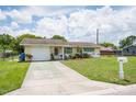 Front exterior of home showing the garage, driveway and front yard at 10600 Oleander Dr, Port Richey, FL 34668