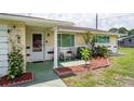 Inviting front porch with decorative plants and comfortable seating area at 10600 Oleander Dr, Port Richey, FL 34668