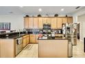 Well-equipped kitchen with stainless steel appliances, granite countertops, and ample cabinet space at 11204 Biddeford Pl, New Port Richey, FL 34654
