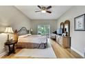 Inviting main bedroom featuring hardwood floors, a ceiling fan, and sliding glass doors to the backyard at 11204 Biddeford Pl, New Port Richey, FL 34654