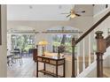 Bright living room with tile floors, staircase, and sliding doors that bring in natural light and scenic views at 11418 Tee Time Cir, New Port Richey, FL 34654