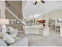 Cozy living room area with a staircase, comfortable seating, and bright lighting at 11418 Tee Time Cir, New Port Richey, FL 34654