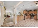 Bright and spacious kitchen with stainless steel appliances and adjacent to the living room at 13027 Beacon Ct, Hudson, FL 34667