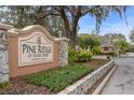 The Pine Ridge at Sugar Creek community entrance, a deed restricted community, and landscaped grounds at 13134 Cypress Hill Dr, Hudson, FL 34669