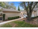 Villa with a two-car garage, tidy landscaping, gated front entry, and an outdoor patio area at 13134 Cypress Hill Dr, Hudson, FL 34669
