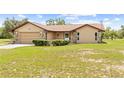 Charming single story home with an attached garage, manicured landscaping and stone accents at 13180 Montour St, Brooksville, FL 34613