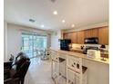 Eat-in kitchen featuring granite countertops, stainless steel appliances, and a breakfast bar at 14655 Potterton Cir, Hudson, FL 34667