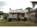 Exterior view of a vintage home showcasing a covered porch and classic architectural design at 1601 Dixie Hwy, Tarpon Springs, FL 34689