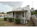 Exterior of a home featuring a covered porch with lattice trim and vintage details at 1601 Dixie Hwy, Tarpon Springs, FL 34689