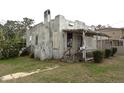 Home exterior featuring a covered porch with lattice details, set in a yard at 1601 Dixie Hwy, Tarpon Springs, FL 34689