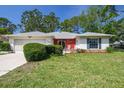 Charming one-story home with a well-manicured lawn and cozy front porch at 2183 Westchester Blvd, Spring Hill, FL 34606