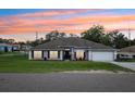 Charming single-story home with a well-manicured lawn, and lush flowerbeds enhancing its curb appeal at 2251 Evenglow Ave, Spring Hill, FL 34609
