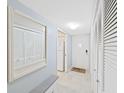 Hallway view with a hall closet, a mirror, and easy access to kitchen area in the home at 2261 Swedish Dr # 37, Clearwater, FL 33763