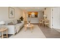 Bright living room showcasing modern furnishings and an open floor plan leading to the kitchen and dining area at 2500 Winding Creek Blvd # G106, Clearwater, FL 33761