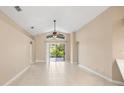 Bright living room featuring tile floors, ceiling fan, and sliding glass doors to lanai at 252 Arbor Woods Cir, Oldsmar, FL 34677