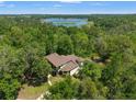 Beautiful aerial view of a sprawling home surrounded by lush trees, highlighting the home's privacy and scenic location at 25487 Dan Brown Hill Rd, Brooksville, FL 34602