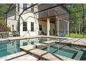 Relaxing backyard pool with a built-in spa and screened enclosure, perfect for enjoying the outdoors at 25487 Dan Brown Hill Rd, Brooksville, FL 34602