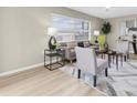 Cozy living room with a large window, neutral-toned furniture, and a stylish area rug over wood flooring at 2954 Leisure Ct, Dunedin, FL 34698