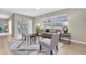 Inviting living room with a large window and sliding glass door to the backyard, creating a seamless indoor-outdoor flow at 2954 Leisure Ct, Dunedin, FL 34698