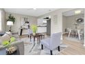 Bright living room featuring modern decor, a view into the updated kitchen and an adjacent dining area at 2954 Leisure Ct, Dunedin, FL 34698