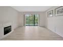 Open living room area with new floors and decorative fireplace at 3134 Lake Pine Way # F2, Tarpon Springs, FL 34688