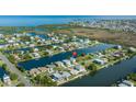 Wide aerial shot of homes in a waterfront community with ocean access and winding waterways at 3363 Poinsettia Dr, Hernando Beach, FL 34607