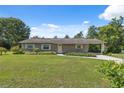 Well-maintained single-story home featuring an attached carport and manicured front yard at 37722 Granada Ave, Dade City, FL 33525