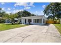 Exterior view of home featuring well-maintained lawn and long driveway at 4007 S Renellie Dr, Tampa, FL 33611