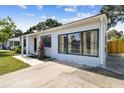 Exterior view of this well-maintained home showcasing a lush lawn and walkway at 4007 S Renellie Dr, Tampa, FL 33611
