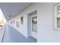 Well-maintained building exterior with access to the unit, enhanced by a decorative wreath at 4939 Floramar Ter # 203, New Port Richey, FL 34652
