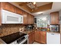 Cozy kitchen with granite countertops, modern appliances, and ample natural light for enjoyable cooking at 4939 Floramar Ter # 203, New Port Richey, FL 34652
