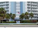 Close up of the building, sign, and the American flag at 4939 Floramar Ter # 812, New Port Richey, FL 34652