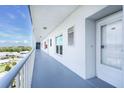 Long hallway, with windows and white stucco walls at 4939 Floramar Ter # 812, New Port Richey, FL 34652