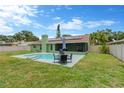 Inviting backyard with pool, screened-in patio, and seating area for outdoor enjoyment at 5021 Bridgeport Dr, Safety Harbor, FL 34695